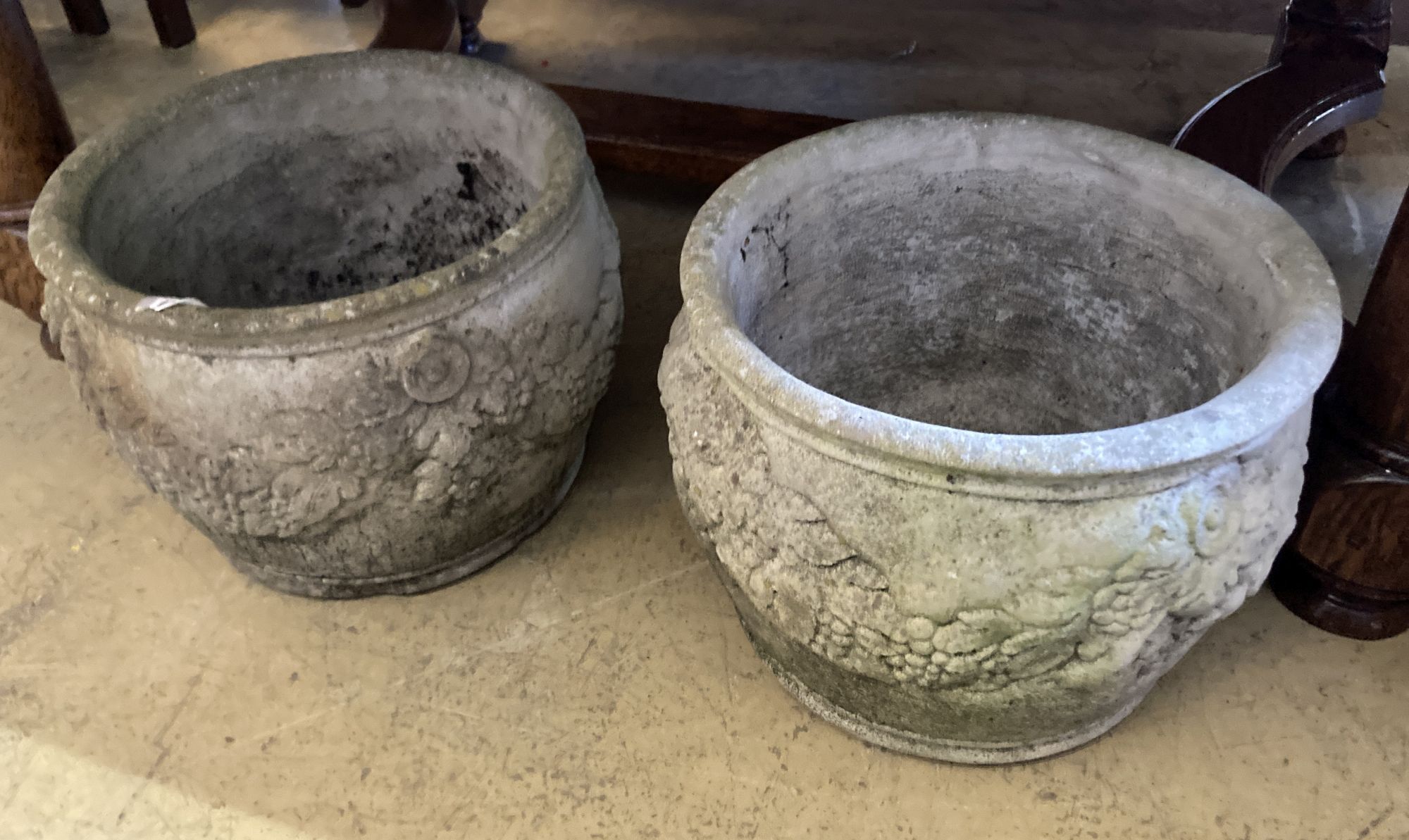 A pair of reconstituted stone circular garden planters, diameter 36cm, height 26cm